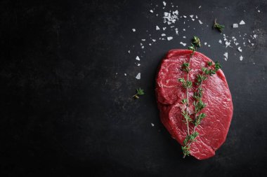 Raw meat with spices, herbs and salt ready for cooking on table. Closeup. 