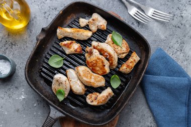 Grilled chicken breast on pan on table. View from above