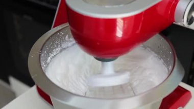 Elektrikli mikser, kabarık kremalı pasta için yumurta beyazı çırpıyor. Pişirme süreci, tatlı hazırlama ve aşçılık konsepti..