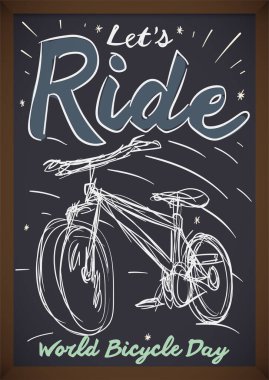 Dünya Bisiklet Günü 'nde bisiklet çizimi ve davetiyesi olan siyah yazı tahtası.