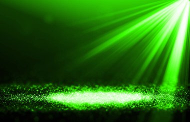 Yeşil ışıltılı ışınlar, sahne ışıkları, soyut arkaplanda zarif bir gösteri sunar. Toz, arka planda kıvılcımlar oluşturur.