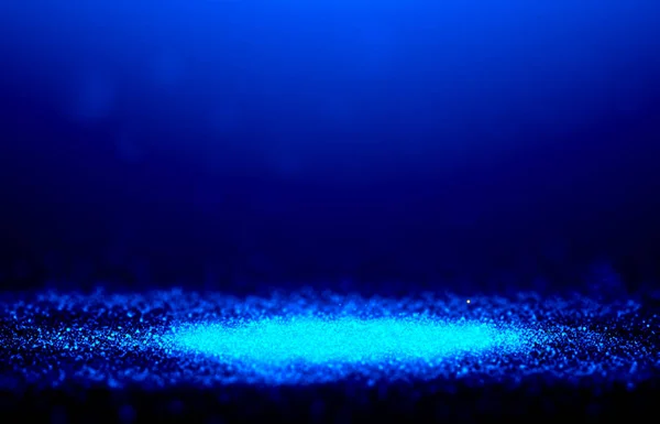 Blue sparkle rays glitter lights with spotlight bokeh elegant show on stage abstract background. Dust sparks background.Spotlight background