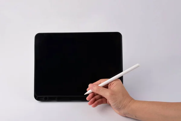 Pen in hand and smartphone and black stylus for writing isolated on white background.