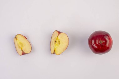 Falling red apple slice isolated on white background.