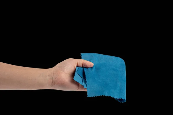 El ve buruşuk mikrofiber temizleme bezi, siyah arka planda izole edilmiş.
