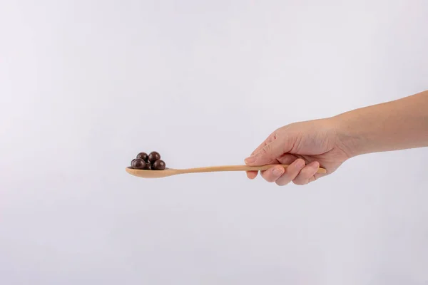 Chocolate Balls Wooden Spoon Hand White Background — Stock Photo, Image