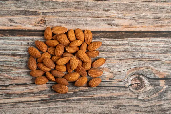 stock image Almonds seed on wooden background