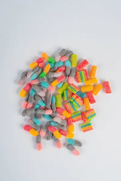 stock image Sour tasting colorful gummy worms as line on white background