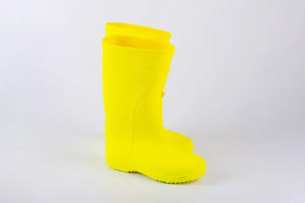 Beyaz arkaplanda izole edilmiş sarı lastik çizmeler