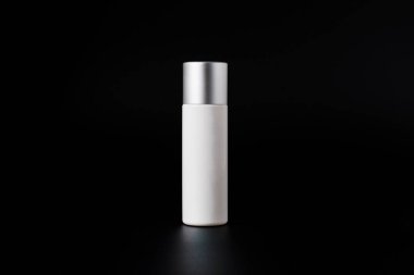 Krem veya losyon için plastik beyaz tüp. Cilt bakımı ya da güneş kremi kozmetik ürünleri siyah arka planda şık dekorlar.