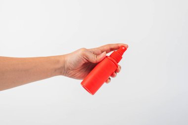 Beyaz arka planda kozmetik kırmızı şişe ve el, şişe, losyon veya serum.. 