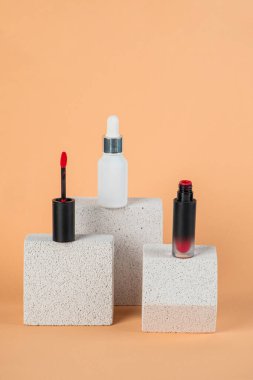 Siyah, boş, ince bir tüp. Rimel, dudak parlatıcısı, jöle, göz kalemi, yağ vs. Krema arka planında şık dekorları olan kozmetik paketler..