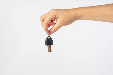 Black locker key in hand on white background