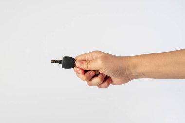 Black locker key in hand on white background