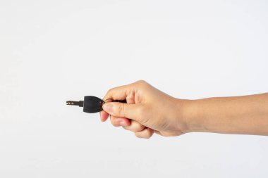 Black locker key in hand on white background