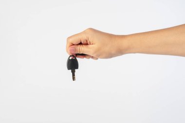 Black locker key in hand on white background
