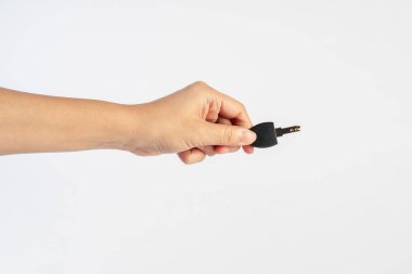 Black locker key in hand on white background