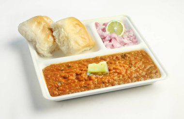 The famous tasty Indian dish - Pav bhaji (bread sabzi) with butter. onion and lemon clipart