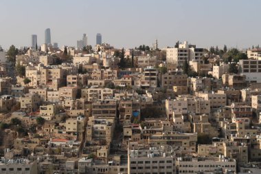 View onto an older part of Amman with skyscrapers in the background, contrast between old and modern Amman, Jordan 2021