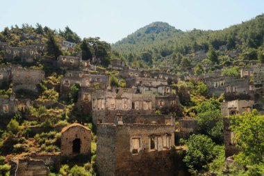 Remains of houses on a hill in the abandoned village of Kayakoy, Livissi, close to Fethiye, Turkey 2022 clipart