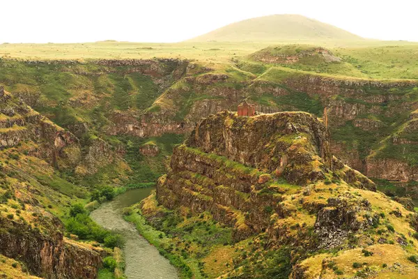 stock image Spectacular view on the promontory encircled by the canyon of the Akhurian River with the ruins of the Church of Saint Elia, Zakares Church on top, last remaining building of the Kizkale, Kiz Kalesi, Maidens, Virgins Castle, ancient site of Ani, Kars