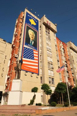 The famous Bill Clinton Statue in front of a big Bill Clinton Banner and next to an american flag on Bill Clinton Boulevard, Prishtina, Pristina, Kosovo, 25th of July 2022 clipart