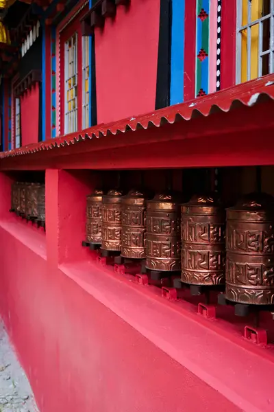 stock image The copper prayer wheels on the colorful facade of the monastery in Monjo, Manjo village, Mount Everest Basecamp Trek, EBC, Nepal 2022