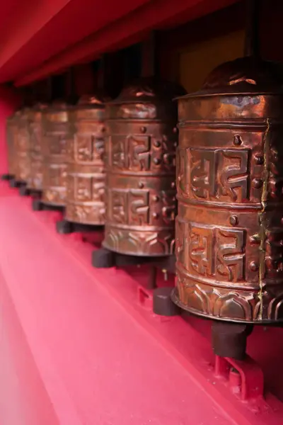 stock image The copper prayer wheels on the bright red facade of the monastery in Monjo, Manjo village, Mount Everest Basecamp Trek, EBC, Nepal 2022