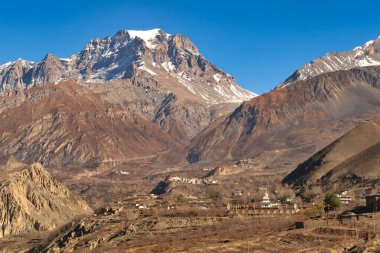 View onto Jangchup Choeten Temple, Pagoda, the village of Jharkot and the town of Muktinath in front of the Thorong, Thorung La Pass, Annapurna Circuit Trek, Nepal 2022 clipart