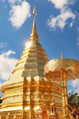 Altın merkezi stupa, mavi gökyüzünün önündeki pagoda, Wat Phra 'da altın bir şemsiye yanında Doi Suthep Tapınağı, güneş ışığı yüzeyinden yansıyor, Chiang Mai, Tayland 2023