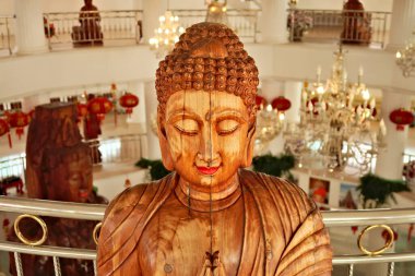 Close up view onto a wooden lady buddha statue inside the Phop Chok Dhamma Chedi, part of the Wat Huay Pla Kang Temple, Complex, Chiang Rai, Thailand 2023 clipart