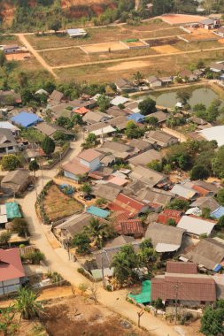 View from the Guan Yin Statue onto a neighborhood of a traditional, rural village right next to it, Wat Huay Pla Kang Temple Complex, Chiang Rai, Thailand 2023 clipart