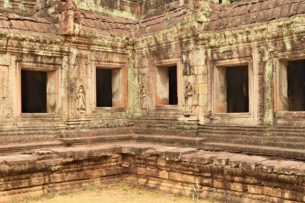 A row of windows at the Prasat Preah Khan Temple, apsaras are carved into the facade, Angkor Wat, Siem Reap, Cambodia 2023