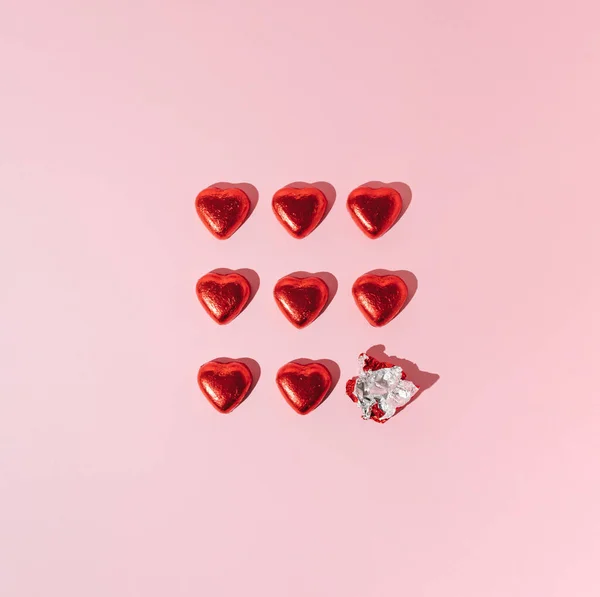 stock image Red heart chocolates on pink background. Creative Valentines or love minimal concept.