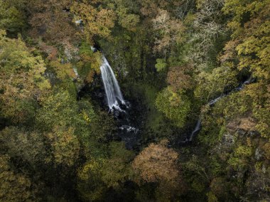 Aerial view of Melincourt waterfall in Autumn at the village of Resolven, South Wales, UK clipart