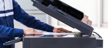İşadamı, yazıcı fotokopi ağı panelindeki düğmeye basar, ofis konseptinde fotokopi üzerinde çalışır, yazıcı, kağıt tarama ve kopyalama için ofis çalışanı ekipmanıdır.