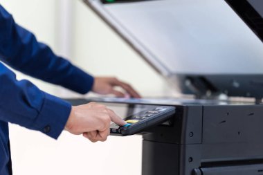 İşadamı, yazıcı fotokopi ağı panelindeki düğmeye basar, ofis konseptinde fotokopi üzerinde çalışır, yazıcı, kağıt tarama ve kopyalama için ofis çalışanı ekipmanıdır.