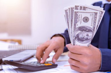 Business accountants or bankers perform savings calculations, financial accounting, business banking and economic concepts. Picture of a hand using a calculator on a desk on workplace expenses.