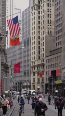 NEW YORK, ABD - 23 Şubat 2024: Arkaplanda yükselen gökdelenleri ile çok sayıda Amerikan bayraklarını gösteren enerjik bir şehir sahnesi