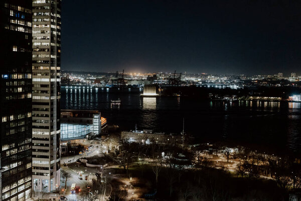 A stunning nighttime view of a city skyline featuring illuminated buildings and a sprawling landscape in New York