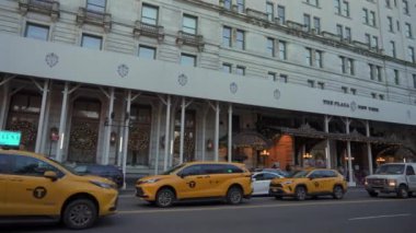 NEW YORK, ABD - 29, 2024 İkonik Plaza Oteli hareketli sarı NYC taksileriyle çevrili, şehirde canlı bir şehir atmosferi yaratıyor