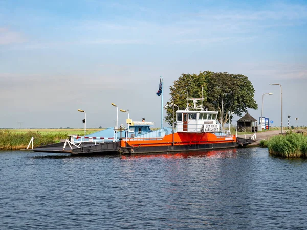 stock image ZWARTSLUIS, NETHERLANDS - SEP 26, 2021: Motorised cable pontoon ferry boat between Zwartsluis and Genemuiden on Zwarte Water river, Overijssel