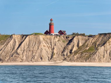 Ferring, Denmark - Sep 7, 2023: Bovbjerg lighthouse and cliffs from North Sea, Ferring, Lemvig, Central Jutland clipart