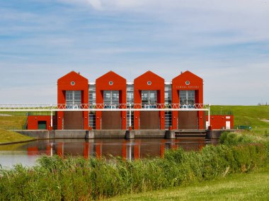 Termunterzijl, Netherlands - Jul 9, 2024: Building of Rozema pumping station for water management in the village of Termunterzijl, Eemsdelta, Groningen clipart