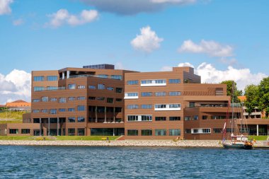 Sonderborg, Denmark - Jul 28, 2024: Waterfront modern Kontor C office building along Alssund Strait, Als Island, Southern Denmark clipart