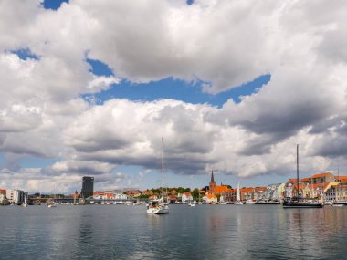 Sonderborg, Denmark - Jul 27, 2024: Sailing boats waiting to pass King Christian X Bridge over Alssund in Soenderborg, Southern Denmark clipart