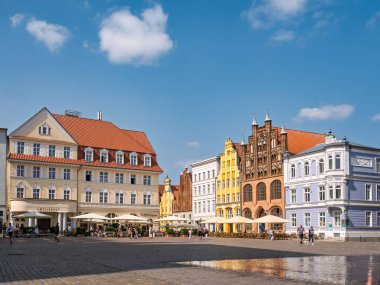 Stralsund, Almanya - 20 Ağustos 2024: Mecklenburg-Vorpommern 'deki renkli Barok ve Brick Gotik kasaba evleri ile eski pazar meydanı