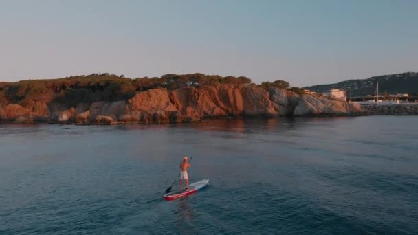 Cinematic Aerial Drone Shot Man Stand Paddle Board Training Sea — Vídeos de Stock