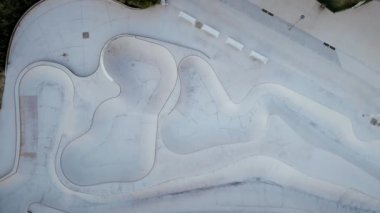 Drone aerial shot of skatepark pool in urban city area. Top-down view. Summer outdoor extreme sport. 