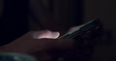 Side view of woman use smartphone, screen lit fingers swipe and scroll through content on the screen. Push buttons, follow links. Nighttime phone using